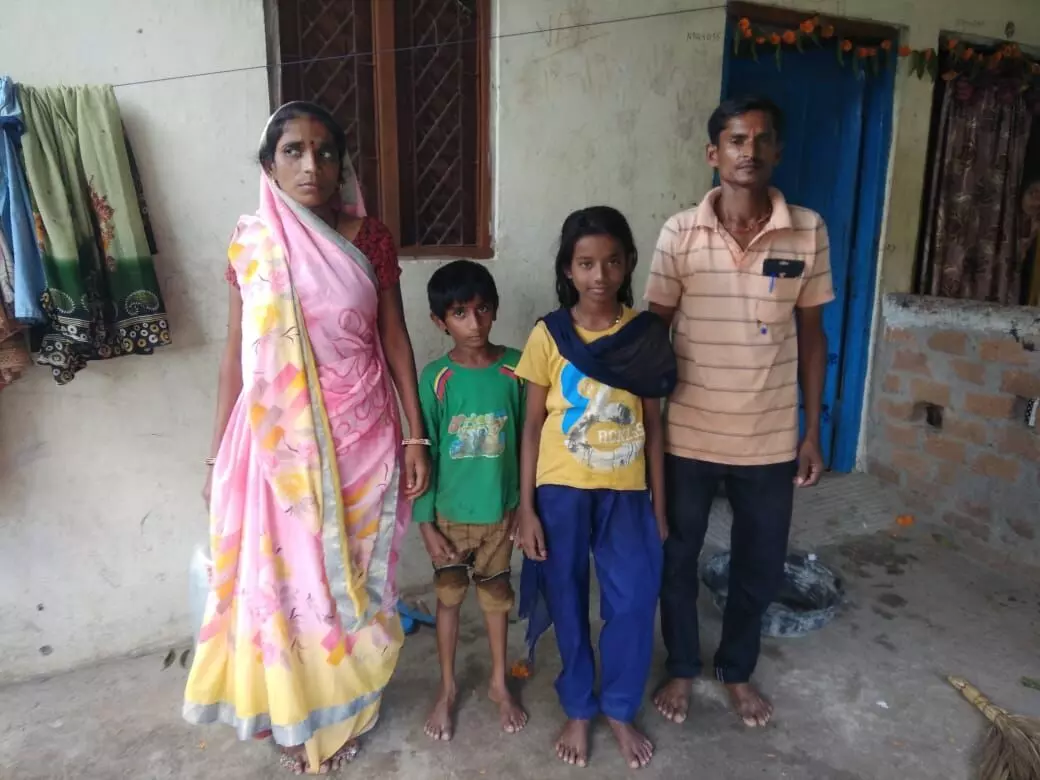 Dali Bai (left) and her husband Chagan Baman (right) with their children.