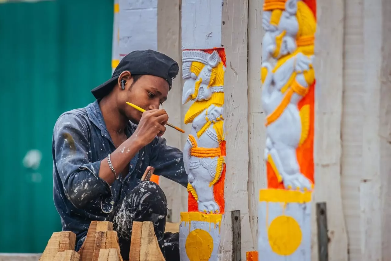 Around 60 painters are busy painting the wheels and other parts of the chariots.