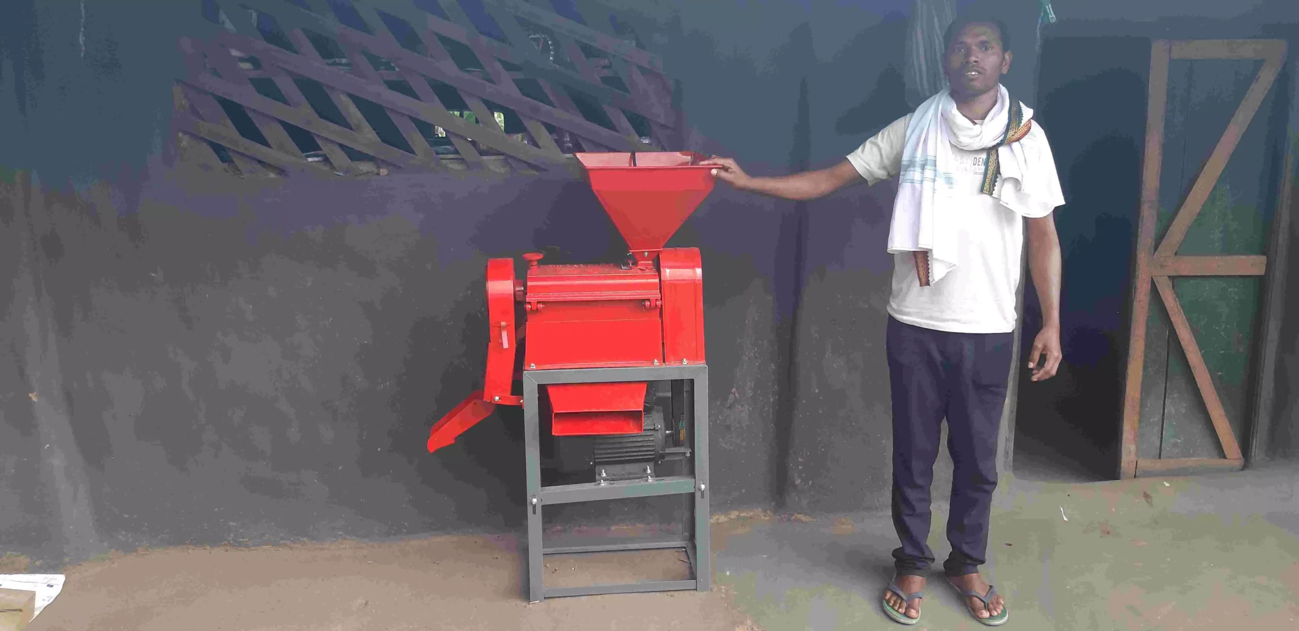 Saraipani villager with paddy processing machine as new source of income after power supplied through solar grid.