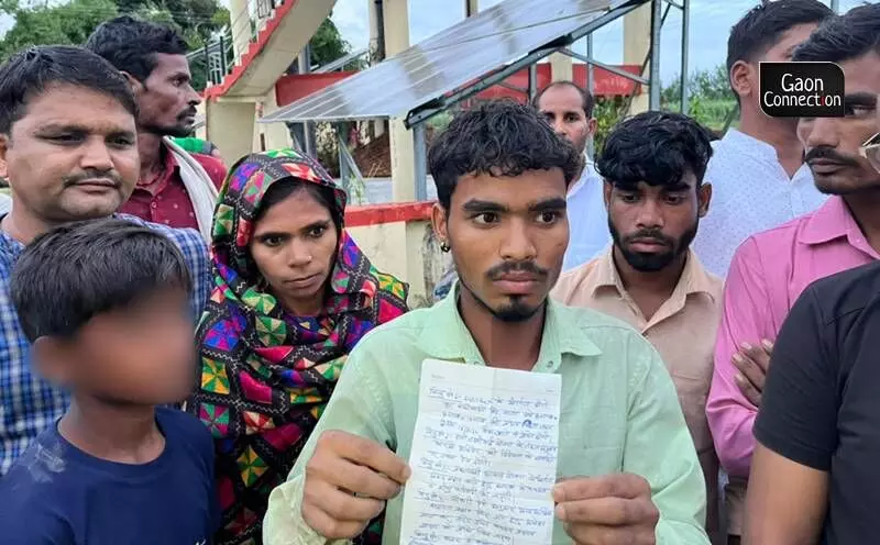 Uttam Kumar, the victims brother holding the written assurance of compensation. Photo by Dharmendra Rajpoot