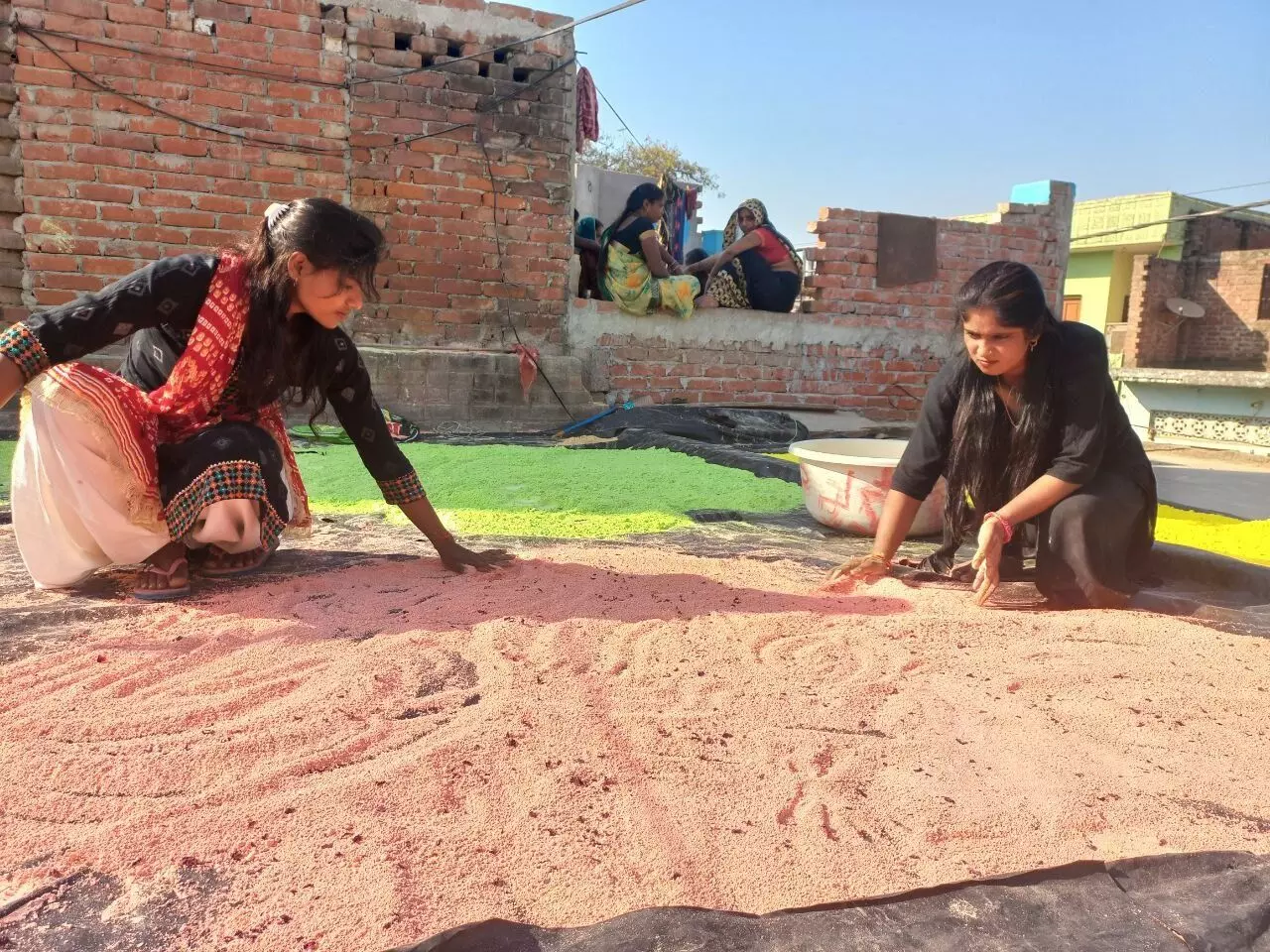 The women aremaking gulal (coloured powder) for the spring festival by extracting colours from vegetables, flowers and fruits.