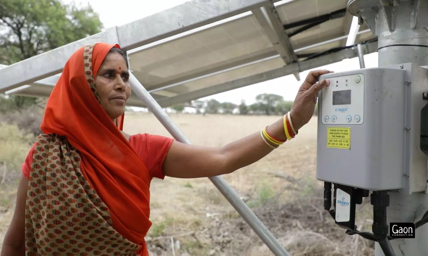 Geeta Devi, a farmer in Lamora village of Mahoba, Uttar Pradesh presses a button to start the solar-powered irrigation pump.