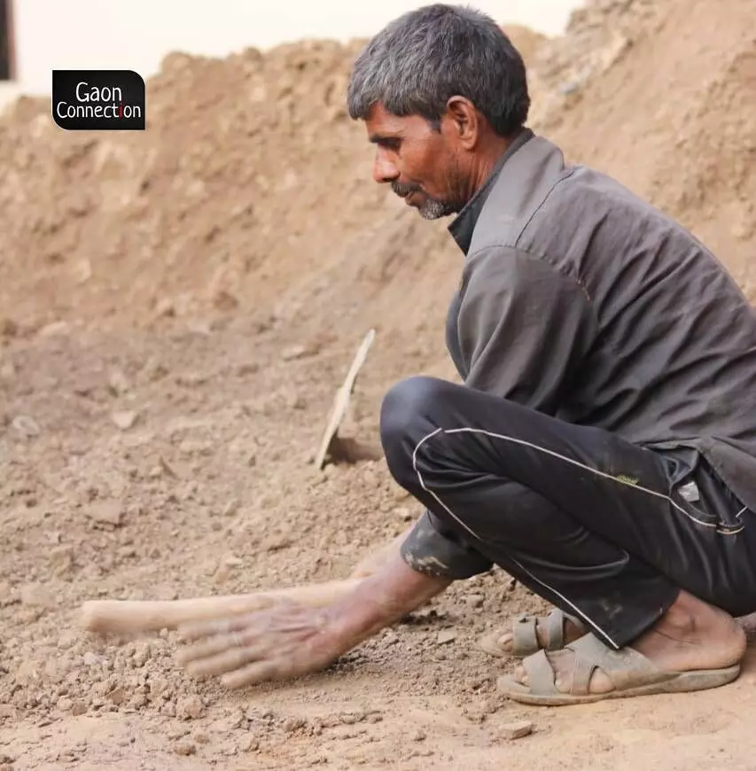 A potter sourcing mud for pottery.