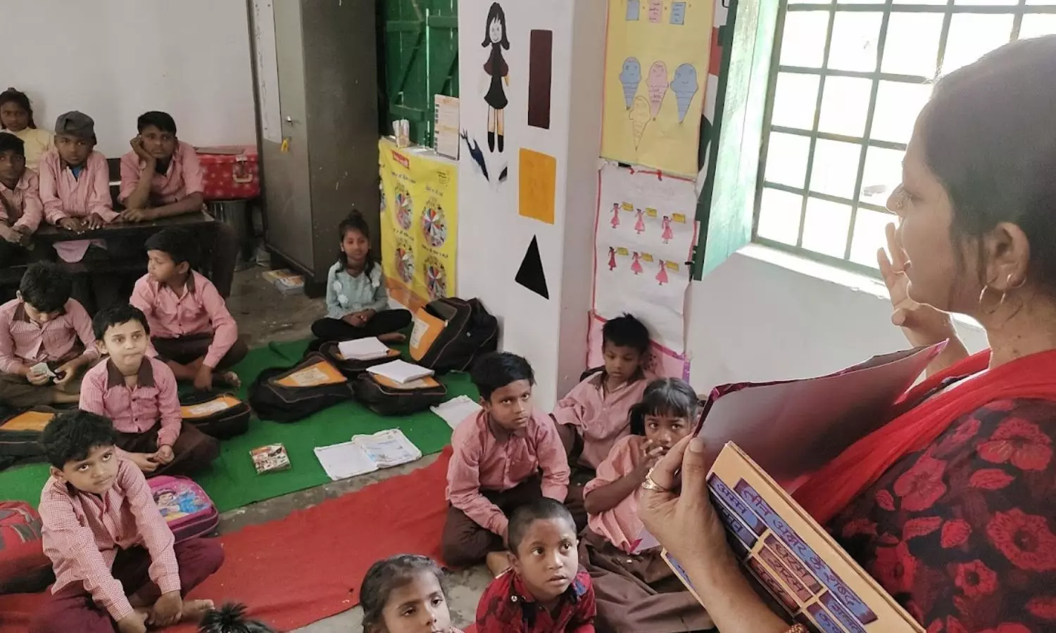 Jahan instructs her students to solve the problems given in the workbooks before she leaves the classroom.