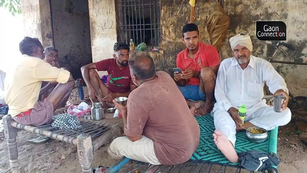 Villagers having lunch after volunteers distributed food-aid. Photo by Brijendra Dubey