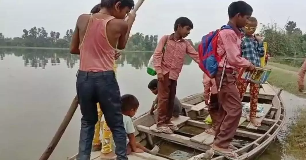 Students in the flood affected areas row their boats to reach school.