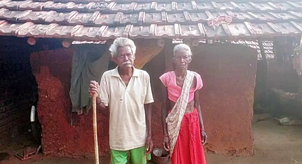 Bhuktu Murmus parents standing outside their house.Bhuktu had promised them wollens this winters.