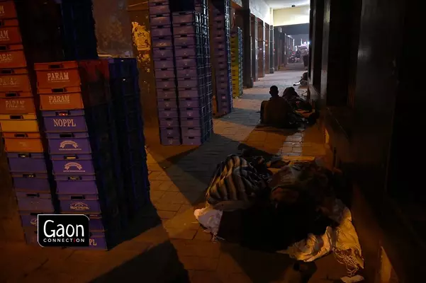 Workers who load milk packets on trays are seen sleeping in Old Delhi area.